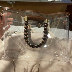 Cute see through purse. Good for football games. Used once. Bends weird alone.
